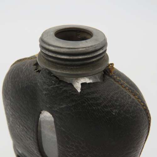 Antique leather clad glass hip flask with pewter lid and cup