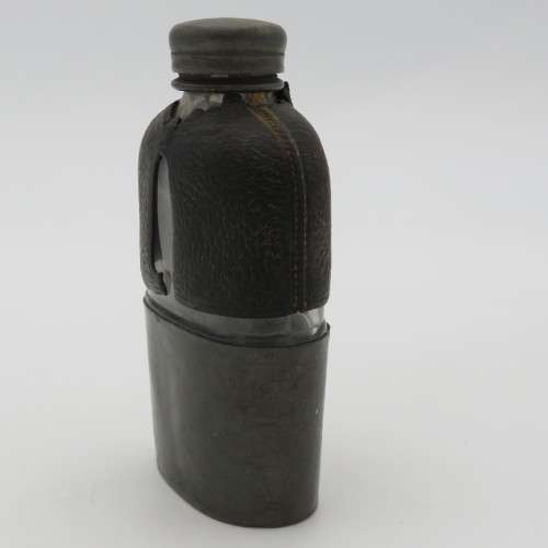 Antique leather clad glass hip flask with pewter lid and cup