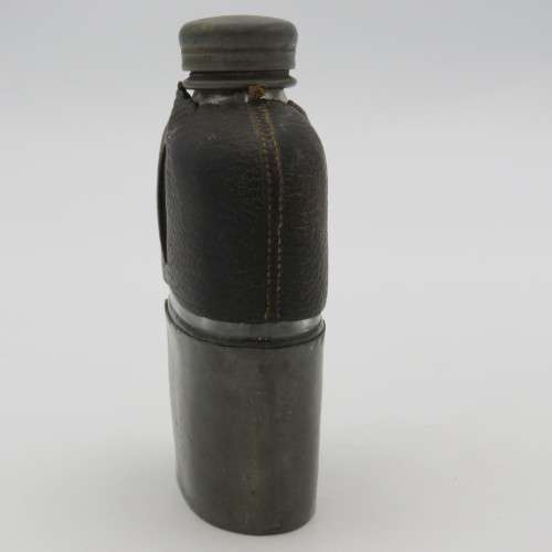 Antique leather clad glass hip flask with pewter lid and cup