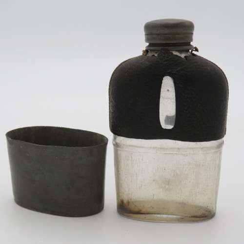 Antique leather clad glass hip flask with pewter lid and cup