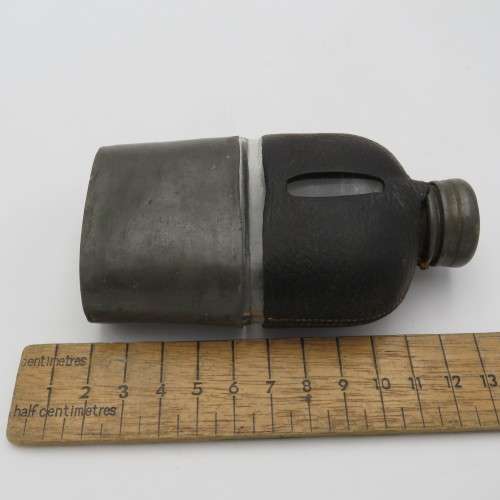 Antique leather clad glass hip flask with pewter lid and cup