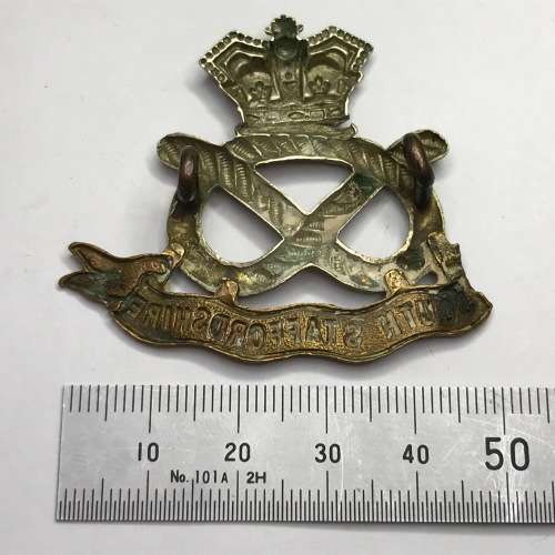 Boer War South Staffordshire Regiment cap badge with lugs - left ribbon broken