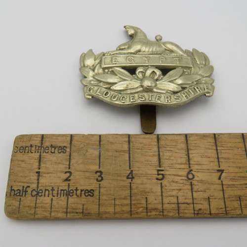 The Gloucestershire regiment cap badge with slide