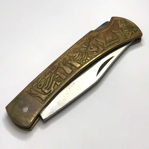 Vintage pocket knife with brass handle and hunting theme