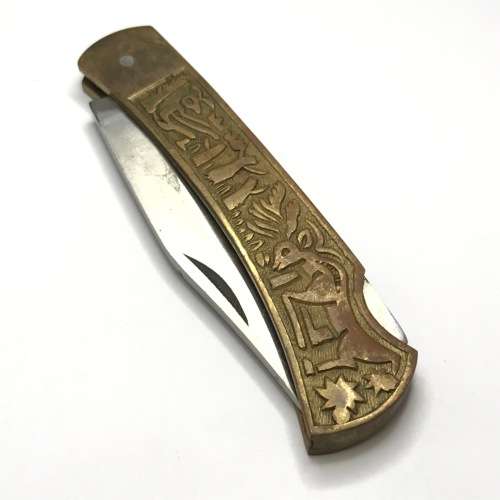 Vintage pocket knife with brass handle and hunting theme