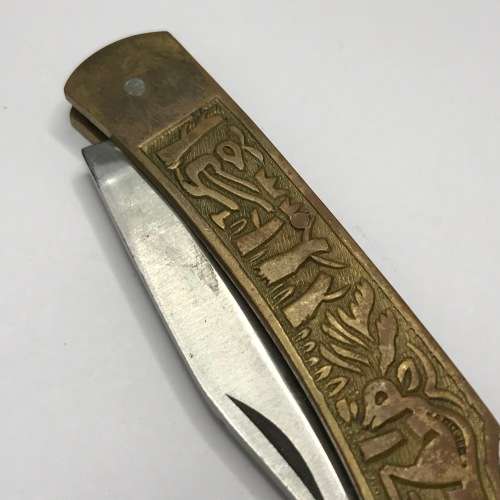 Vintage pocket knife with brass handle and hunting theme