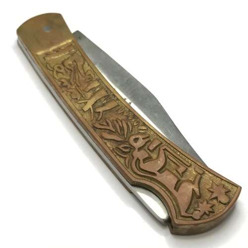 Vintage pocket knife with brass handle and hunting theme