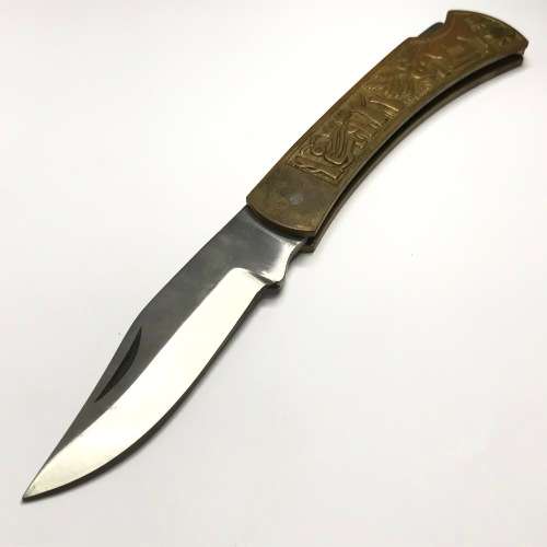 Vintage pocket knife with brass handle and hunting theme