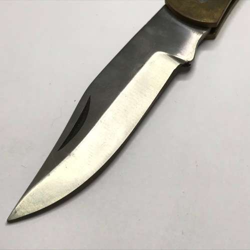 Vintage pocket knife with brass handle and hunting theme