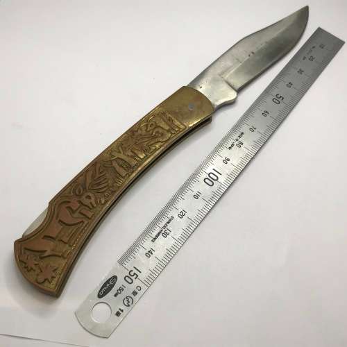 Vintage pocket knife with brass handle and hunting theme