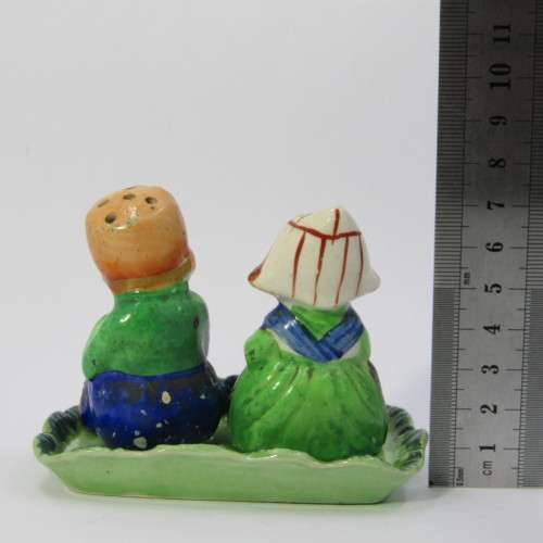Pair of vintage Dutch boy and girl salt and pepper shakers on stand