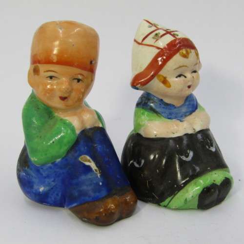 Pair of vintage Dutch boy and girl salt and pepper shakers on stand