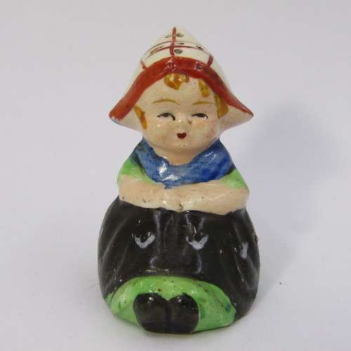 Pair of vintage Dutch boy and girl salt and pepper shakers on stand