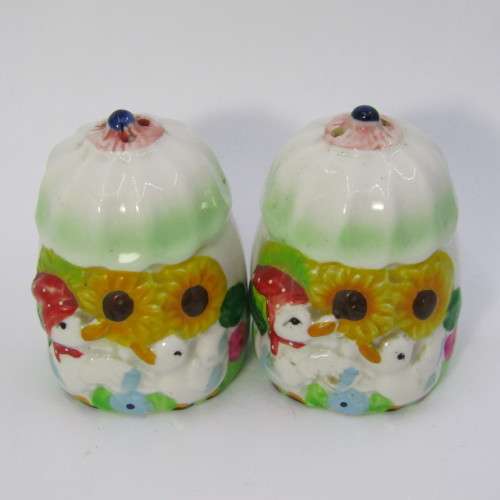 Pair of porcelain salt and pepper shakers with ducks and flowers