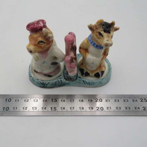Vintage porcelain cow sale and pepper shakers on stand