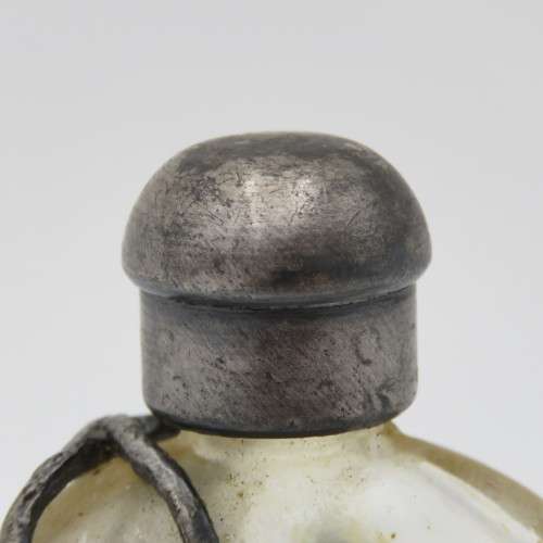 Vintage perfume bottle with silver-plated roses design