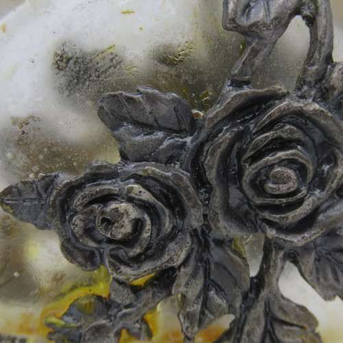 Vintage perfume bottle with silver-plated roses design