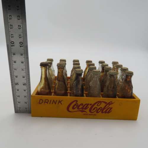 Vintage miniature Coca-Cola bottles in yellow tray - Two Coke bottles missing and was replaced