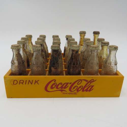 Vintage miniature Coca-Cola bottles in yellow tray - Two Coke bottles missing and was replaced