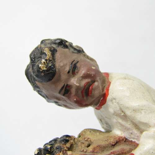 Vintage resin figurine of boy being bitten by bulldog - repaired