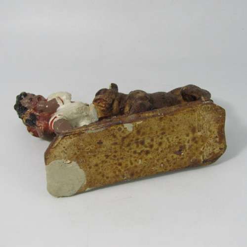 Vintage resin figurine of boy being bitten by bulldog - repaired