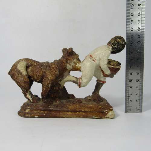 Vintage resin figurine of boy being bitten by bulldog - repaired