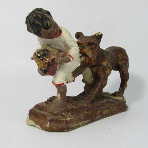 Vintage resin figurine of boy being bitten by bulldog - repaired