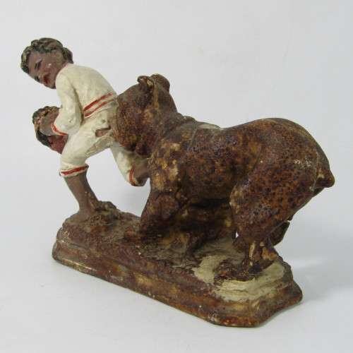 Vintage resin figurine of boy being bitten by bulldog - repaired