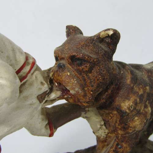 Vintage resin figurine of boy being bitten by bulldog - repaired