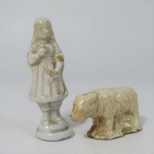 Pair of antique porcelain figurines from coffee tins