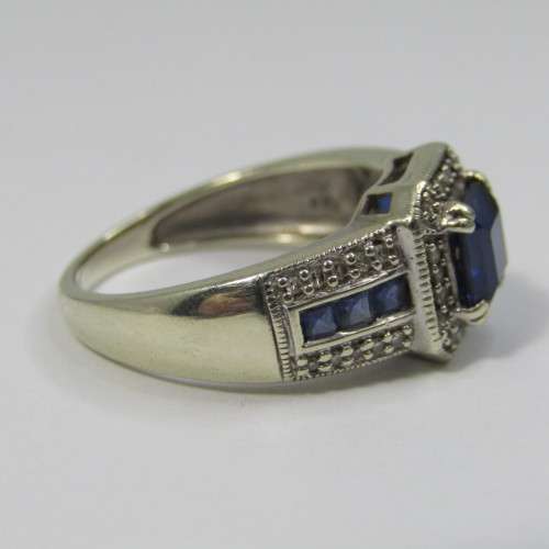 9kt white gold ring with 36 small diamonds plus 7 blue sapphires - weighs 4,3g - size N