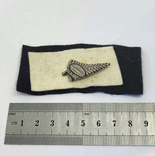 Vintage All Blacks New Zealand rugby pin badge on felt background