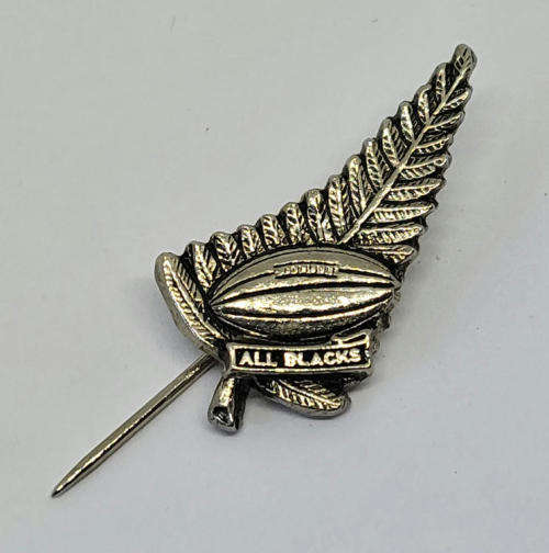 Vintage All Blacks New Zealand rugby pin badge on felt background