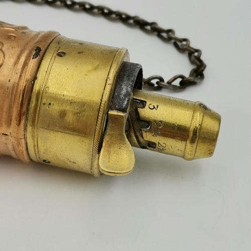 Antique red and yellow copper gun powder flask