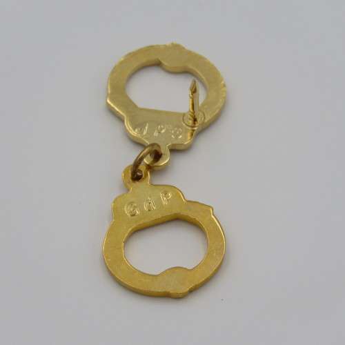 Police handcuffs pin badge