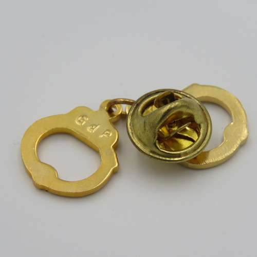 Police handcuffs pin badge