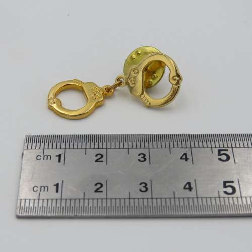 Police handcuffs pin badge