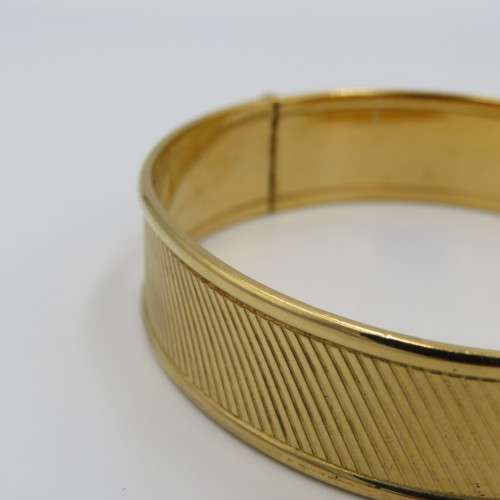 Beautiful gold bangle with safety chain - metal core
