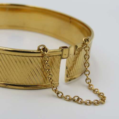 Beautiful gold bangle with safety chain - metal core