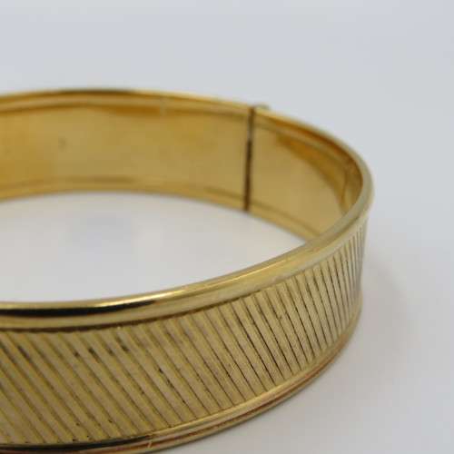 Beautiful gold bangle with safety chain - metal core