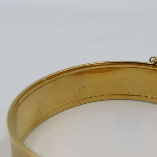 Beautiful gold bangle with safety chain - metal core