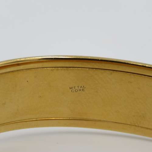 Beautiful gold bangle with safety chain - metal core
