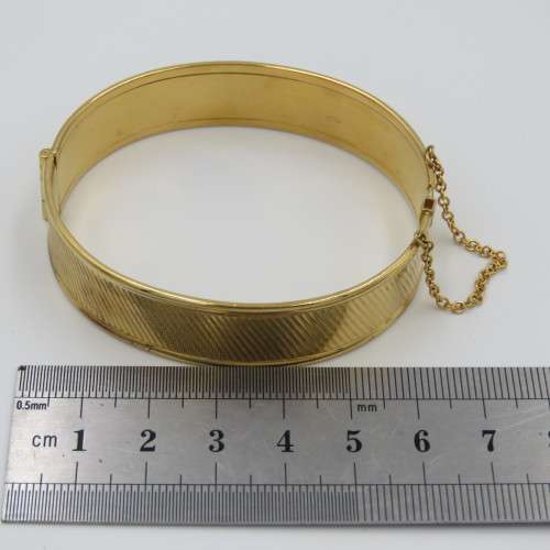 Beautiful gold bangle with safety chain - metal core