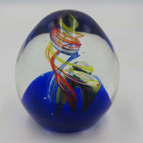 Handmade glass paperweight with spiral design
