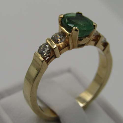 14kt Yellow Gold ring with 4 diamonds totalling 60 points SI / G and emerald of 95 points