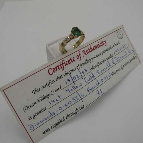 14kt Yellow Gold ring with 4 diamonds totalling 60 points SI / G and emerald of 95 points