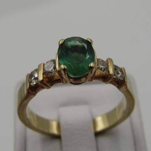 14kt Yellow Gold ring with 4 diamonds totalling 60 points SI / G and emerald of 95 points