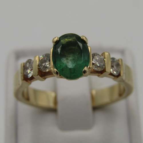 14kt Yellow Gold ring with 4 diamonds totalling 60 points SI / G and emerald of 95 points