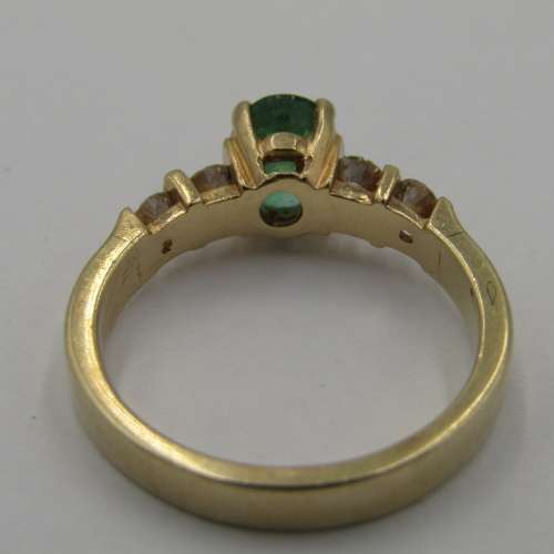 14kt Yellow Gold ring with 4 diamonds totalling 60 points SI / G and emerald of 95 points