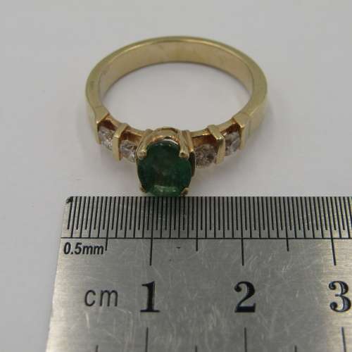 14kt Yellow Gold ring with 4 diamonds totalling 60 points SI / G and emerald of 95 points